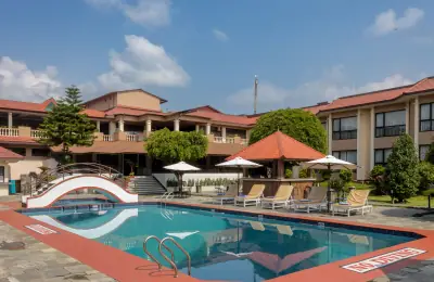 Pokhara Grande - Photo 5 Outdoor swimming pool, bridge and loungers at Pokhara Grande